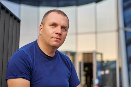 Pensive caucasian man sits near business center.