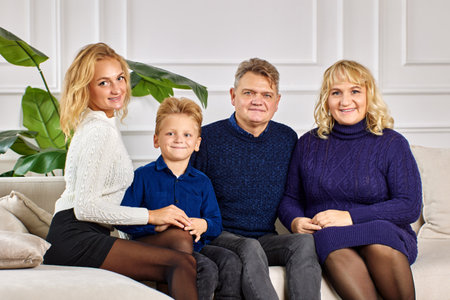 Caucasian family are posing for portrait in living room.の写真素材
