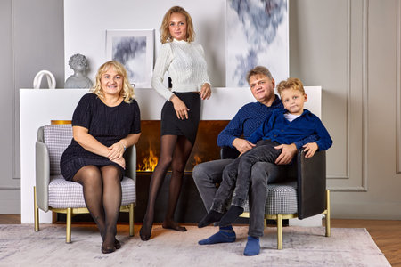 Friendly caucasian family are standing near fireplace at home.
