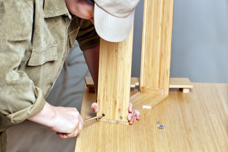 Flat pack furniture assembly by handyman with screwdriver.の写真素材