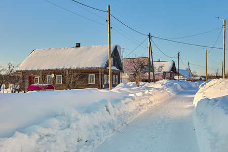 Buildings of northern Europe between snow drifts in countryside in winter.の写真素材