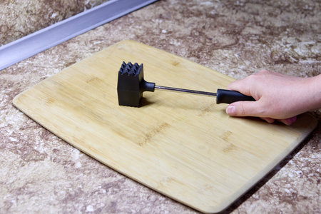 Meat tenderizer tool is meat pounder for strike steak or chicken breasts with meat mallet to loosen fibers and make meat softer and smoother.の写真素材