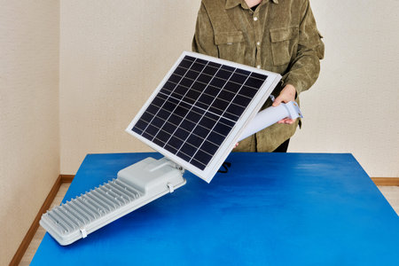 Solar powered led street lights during Installation, screw fixing, connection to mounting arm.