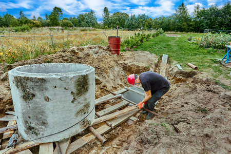 Using roller deck to move concrete ring during installation of septic tank in suburbs.の写真素材
