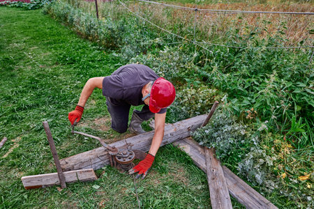 Worker turns handle of manual gear winch.の写真素材