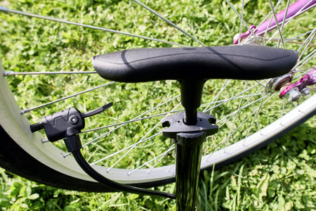 Inflating bicycle tire using floor pump with presta and schrader valve adapter.の写真素材
