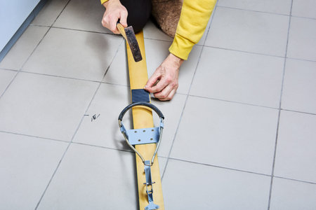 Heel pad for universal cable ski bindings with free heel is attached to wooden skis with mounting nails.の写真素材