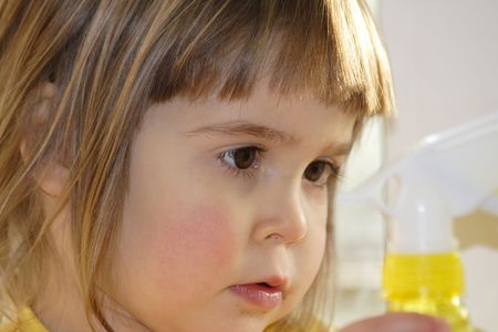 little blond girl with long eyelashes thinking, reflectingの写真素材