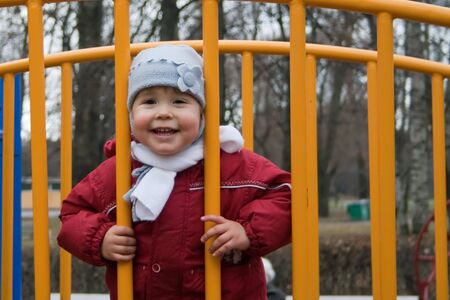 child is playing in colorful construction at the playgroundの写真素材