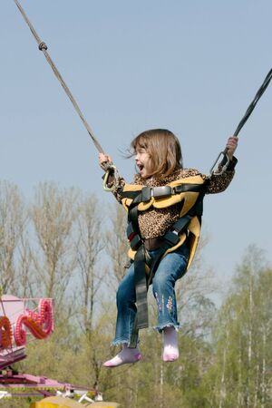little girl is jumping and laughingの写真素材