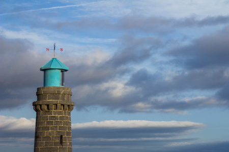 Top of Teignmouth lighthouse against a cloudy skyの写真素材