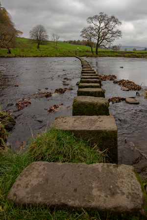 Stepping stones on a public footpath crossing the River Hodder near The Inn at Whitewell, Lancashire, England, United Kingdomの写真素材