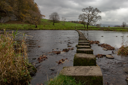 Stepping stones on a public footpath crossing the River Hodder near The Inn at Whitewell, Lancashire, England, United Kingdomの写真素材