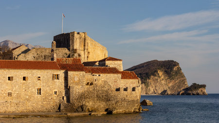 The late afternoon sun makes the walls of Old Town Budva glow