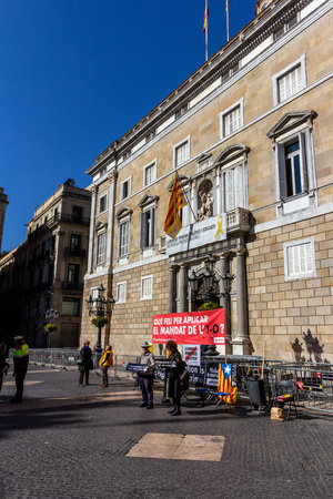 Barcelona, Spain - February 26, 2019 - Protesters gather in front of the Catalonian Government building (Palau de la Generalitat) while tourists pass byのeditorial素材