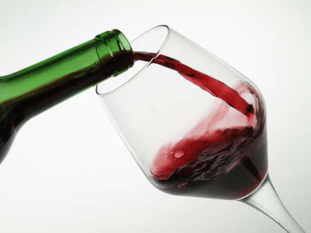 Filling a glass of red wine の写真素材