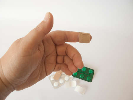 pain. cut index finger glued with adhesive plasterの写真素材