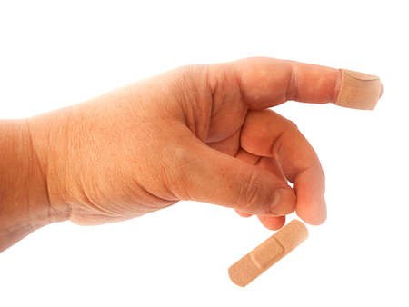 cut index finger taped with adhesive plaster. on a white background.の写真素材