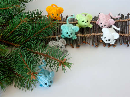 small multi-colored mice and twigs of a Christmas tree on a white background. New Year's decorの写真素材