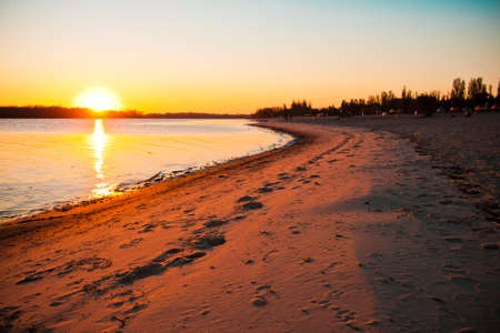 Beautiful sunset on the beach by the riverの写真素材