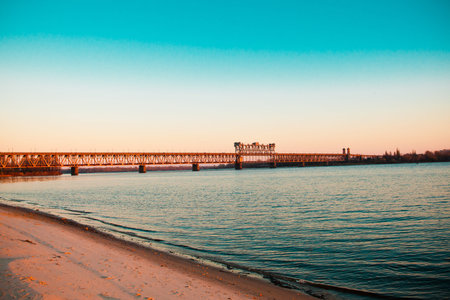 Long bridge over the river and the beach