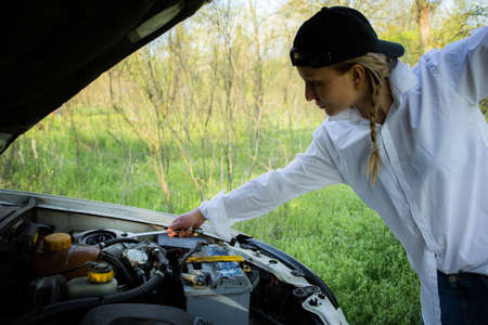 The girl's car broke down, vehicle repairの写真素材