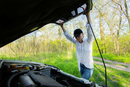 The girl's car broke down, vehicle repairの写真素材