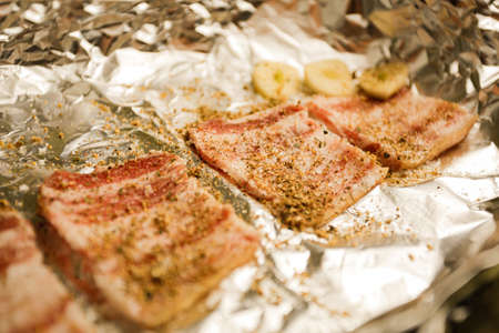 Preparation of billet, balyk with salt and pepper. Foil roastingの写真素材