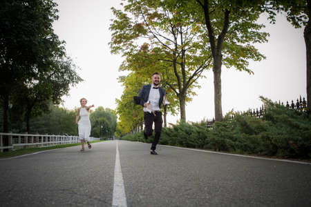 The groom runs away from the brideの写真素材