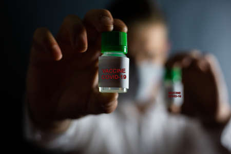 Coronavirus vaccine and masked man, COVID-19の写真素材