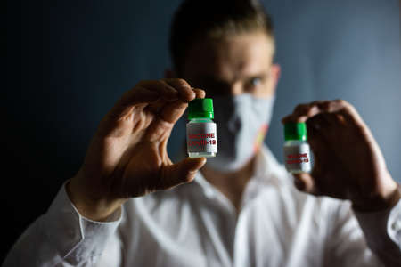 Coronavirus vaccine and masked man, COVID-19の写真素材