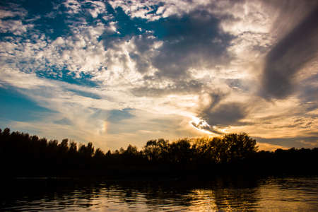 Incredible sunset over the river with cloudsの写真素材