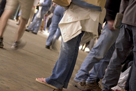 people from the waist down in the subway