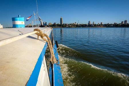 Passenger boat crossing the riverの写真素材