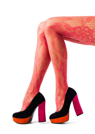 Beautiful women legs with red tights and high heel shoesの写真素材