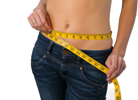 Fit woman measuring her waistの写真素材