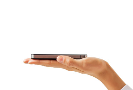 Mobile phone in palm isolated on white background