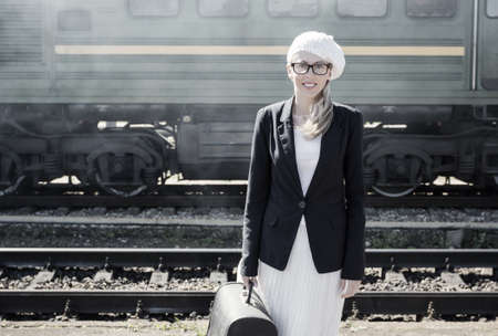 Young woman standing in front of trainの写真素材