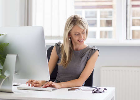 Candid portrait of young creative woman at work  の写真素材