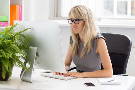 Young creative professional woman working with the computer  の写真素材