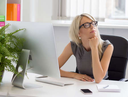 Young entrepreneur dreaming about her business success  の写真素材