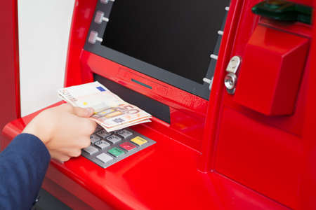 Taking money out of ATMの写真素材
