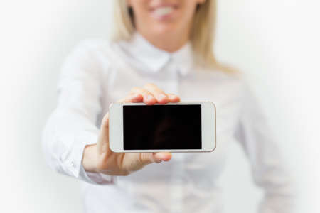 Woman showing blank mobile phoneの写真素材