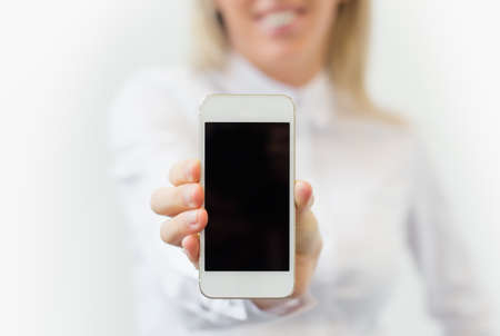 Woman showing blank mobile phoneの写真素材