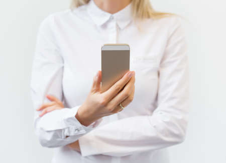 Woman watching mobile phoneの写真素材