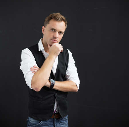 Portrait of serious man against black backgroundの写真素材