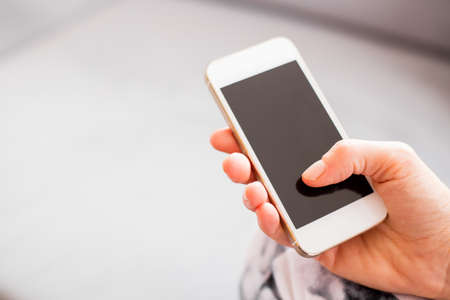 Woman holding smartphone Woman holding smartphone