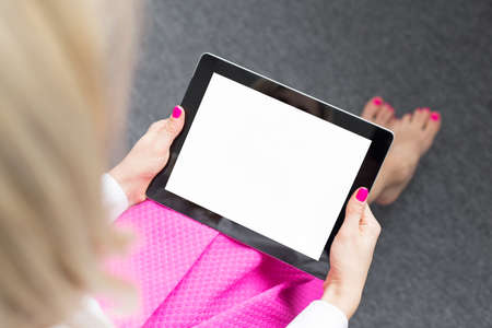 Woman looking at tablet computer\'s screenの写真素材