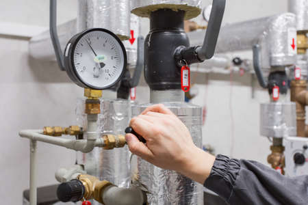 Technician checking water pressureの写真素材