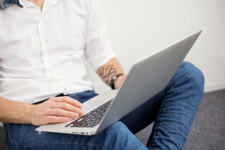 Young man working with laptop computer
